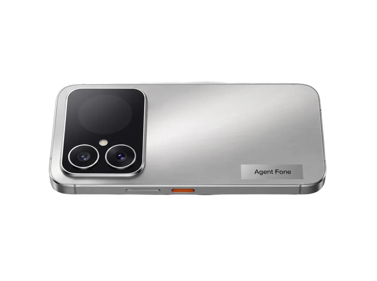 Agent Fone lying flat on a silver-grey ground, rear up: the black camera plateau with two lenses and the circular rear display, one orange agent key on the rail.